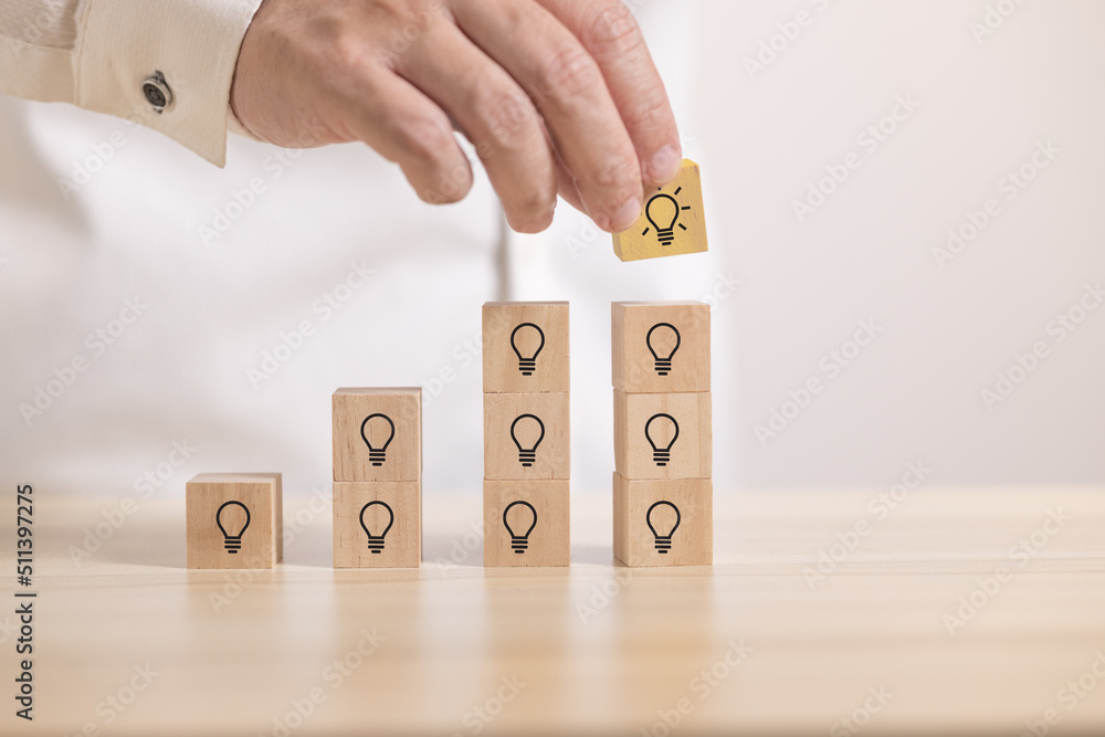 Poster hand stack wooden blocks with thinking and idea icon to graph. Concept for creative and design solution.