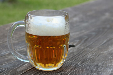 glass of beer on wooden table