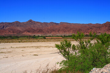 Landscape of the Valles Calchaquies road, Argentina. Mountains of red earth. Dry and desert climate. Tourist path. Trip. Argentine North. Latin America.