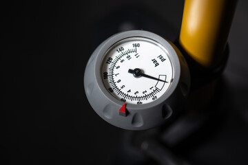 Hand air pump manometer for pressure control on a dark background close-up