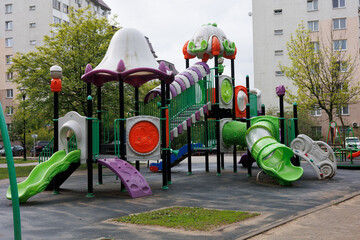Plastic child playground after rain. Russian swing for children. Colorful attractions for children