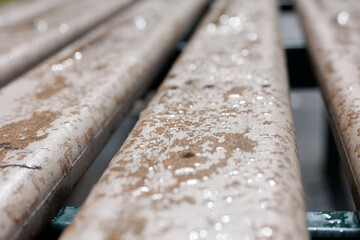 Wet wooden bench after rain. Rain drops on wooden beam