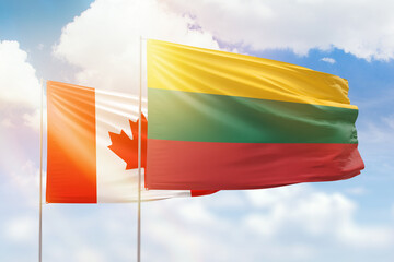 Sunny blue sky and flags of lithuania and canada