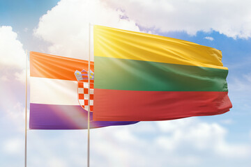Sunny blue sky and flags of lithuania and croatia