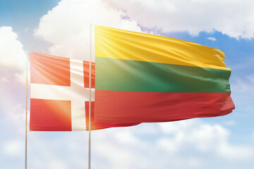 Sunny blue sky and flags of lithuania and denmark
