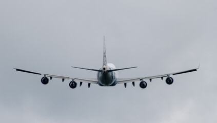 Passenger plane comes in for landing in cloudy weather.