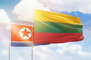 Sunny blue sky and flags of lithuania and north korea