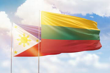 Sunny blue sky and flags of lithuania and philippines