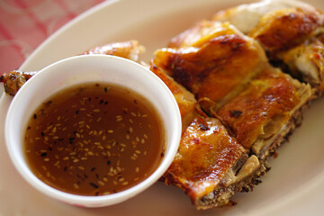 Grilled chicken with dipping sauce on a plate