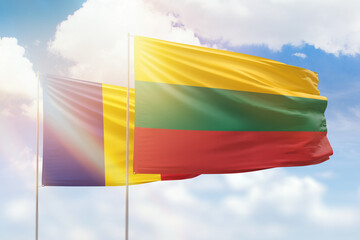 Sunny blue sky and flags of lithuania and romania