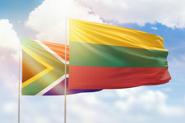 Sunny blue sky and flags of lithuania and south africa