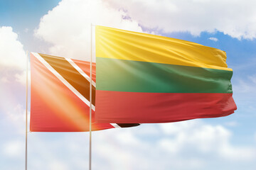 Sunny blue sky and flags of lithuania and trinidad and tobago