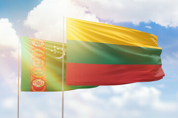 Sunny blue sky and flags of lithuania and turkmenistan