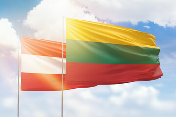 Sunny blue sky and flags of lithuania and austria