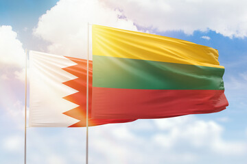 Sunny blue sky and flags of lithuania and bahrain