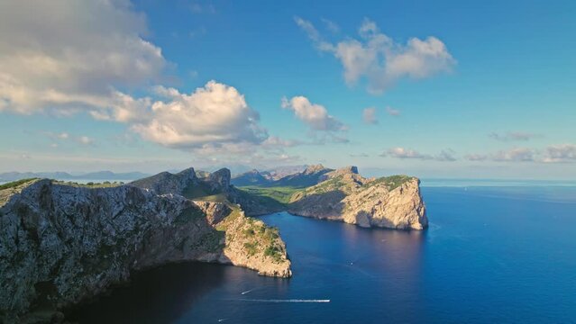 Rocky cliffs by the Mediterranean coastline of Majorca, Balearic Islands, Spain. Panoramic drone view of Cap Formentor in Serra de Tramuntana mountain region.