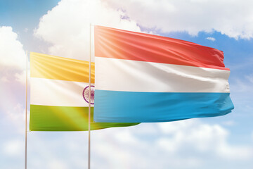 Sunny blue sky and flags of luxembourg and india