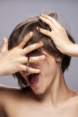 Fototapeta premium Beautiful girl fashion portrait. Happy smiling face expression with hands gesture.