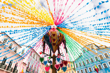 Colorful flags and balloons decorating the feast of Sao Joao in the historic center of Salvador,...