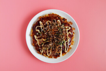 Okonomiyaki in the skillet on the table