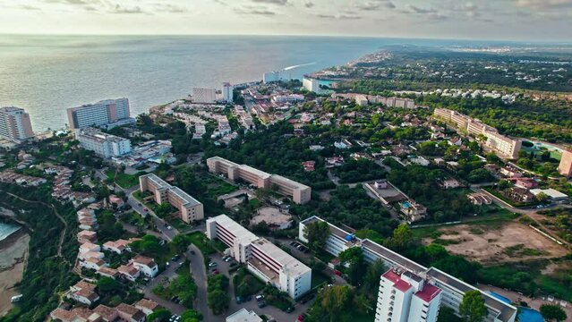 Modern build residence building with pool by the beach on rocky caves in Majorca. Carrer de Cala Antena, Cales de Mallorca, Balearic Islands, Spain.