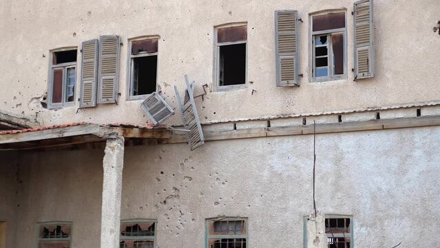 Destroyed building After war with bullet holes

Abandoned ruined after war house with bullet holes, Israel Jordan border


