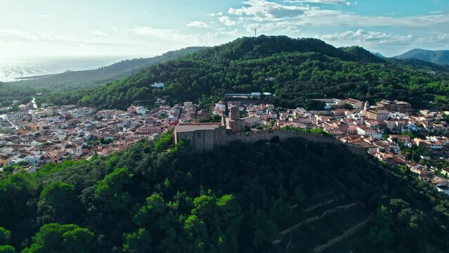 Castell de Capdepera - remains of an ancient stone Spanish castle on Majorca. Panoramic view from above of Capdepera municipality with old traditional houses on Mallorca, Balearic Islands, Spain.