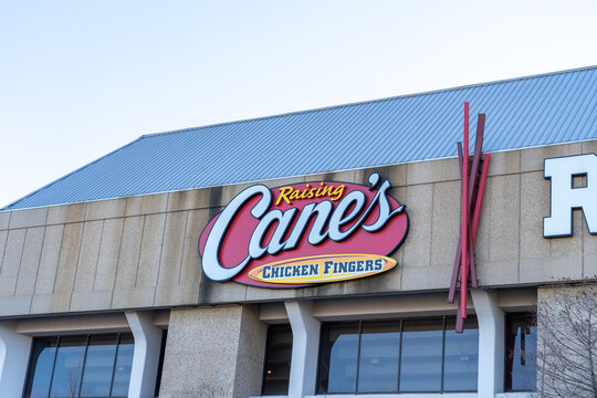 Baton Rouge,  Louisiana, USA- February 13, 2022: Close Up Of Raising Cane's Chicken Fingers Restaurant Sign On The Building. 
Raising Cane's Is Fast-food Chain Specializing In Fried Chicken Fingers.
