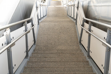 public staircase at station or mall for exit, entrance. stair inside the metro subway with cleanly steel handrail. An empty staircase at a metro station