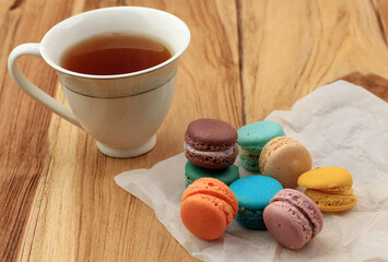 Baby Macaroon on WOoden Table, Served with Tea.