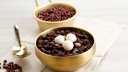 Korean Food Patjuk or Red Bean Porridge Topped with Round Rice Cake