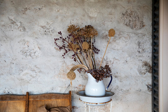 enamel jug with dried flower arrangement