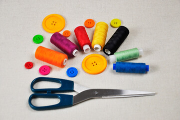 Multicolored thread spools and buttons for sewing clothes.