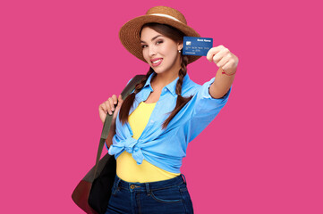 Woman holding credit card over pink isolate background. Studio shot. Online shopping, e-commerce, internet banking, spending money, enjoying life concepts