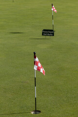 Obraz premium Stockholm, Sweden A putting green at a golfcourse and a sign saying: 