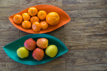Organic Apples oranges and mandarins in trays