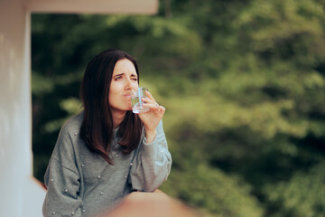 Funny Woman Unhappy with Water Quality and Smell. Disgusted person having a glass of contaminated...