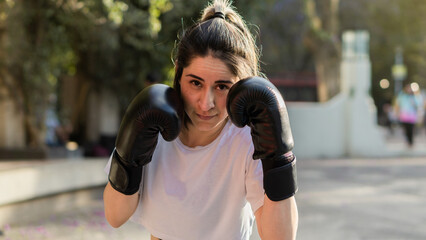Portrait of a beautiful Caucasian woman finishing her boxing classes.