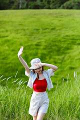 girl with casual outfit relaxing in the park with forest as background