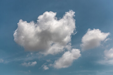 white fluffy clouds in the blue sky .blue sky background with tiny clouds