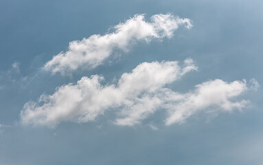 white fluffy clouds in the blue sky .blue sky background with tiny clouds
