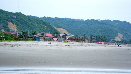 Fototapeta na wymiar Colorful shelters on the beach in Canoa, Ecuador