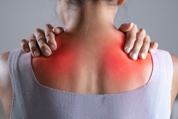 Asian woman has shoulder pain. Female holding painful shoulder with another hands. People with...