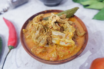  Gulai kambing is Indonesian traditional food, type of food containing rich, spicy and succulent curry-like sauce. The main ingredients is goat meat and coconut milk Selective focus.