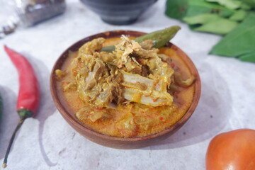  Gulai kambing is Indonesian traditional food, type of food containing rich, spicy and succulent curry-like sauce. The main ingredients is goat meat and coconut milk Selective focus.