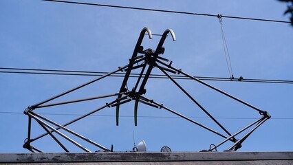 A pantograph or "pan" or "panto" is an apparatus mounted on the roof of an electric train, tram or electric bus to collect power through contact with an overhead line. 