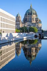 The Berliner Dom with the rebuilt City Palace reflected in the river Spree © elxeneize