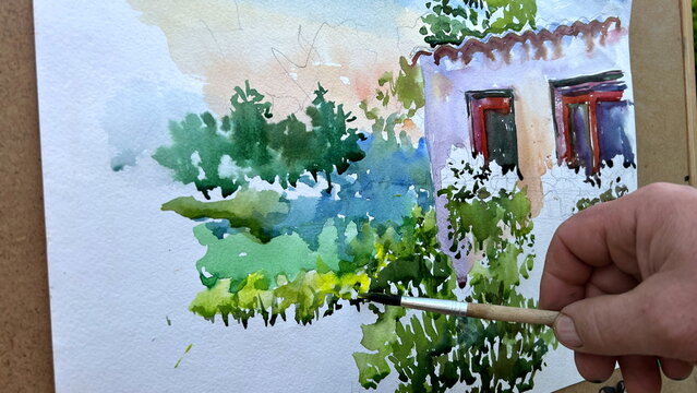 the picture is painted with paints on it depicts a house on the windowsill flowers and around a lot of greenery painting in process of drawing Because some details are underpainted just a white place.