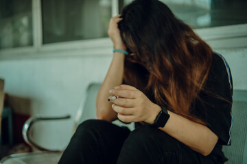 woman wearing black shirt stressing about work hand smoking cigarette unhealthy lifestyle concept