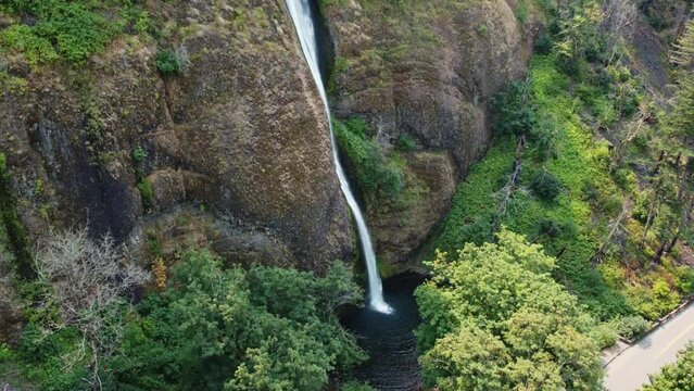 Drone crane shot showcasing Horsetail Falls on the walls of the canyon in the Columbia River Gorge in Oregon. This 4K cinematic nature shot was filmed using a DJI Mini 2 drone.
